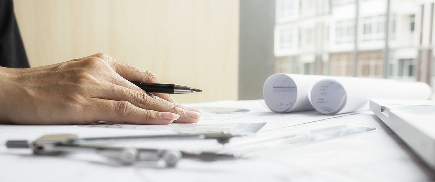 Hands of Engineer working on blueprint,Construction concept. Eng